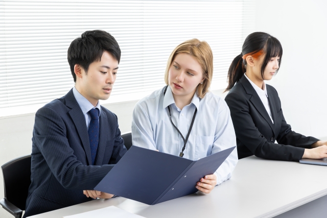 外国人社員に仕事を教えるビジネスマン